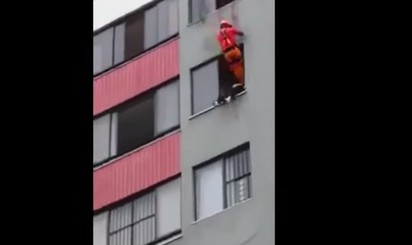 女跳樓坐窗邊 消防員將她踹進去 | 消防員垂降而下將女子踹進屋內